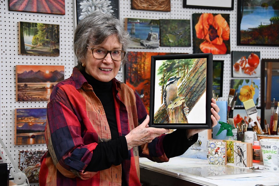 Adrienne Peacock at her home studio in Belcarra. Her woodpecker painting is the featured artwork for marketing materials to promote the 55th annual Port Moody Art Association's show and sale on Nov. 2 and 3, 2024.