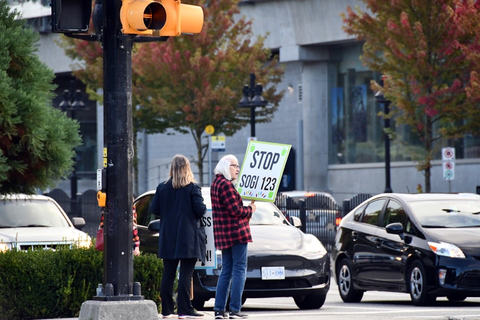 Anti-SOGI protesters stand at the northwestern corner of Pinetree and Guildford ways on Friday, Sept. 20, 2024.