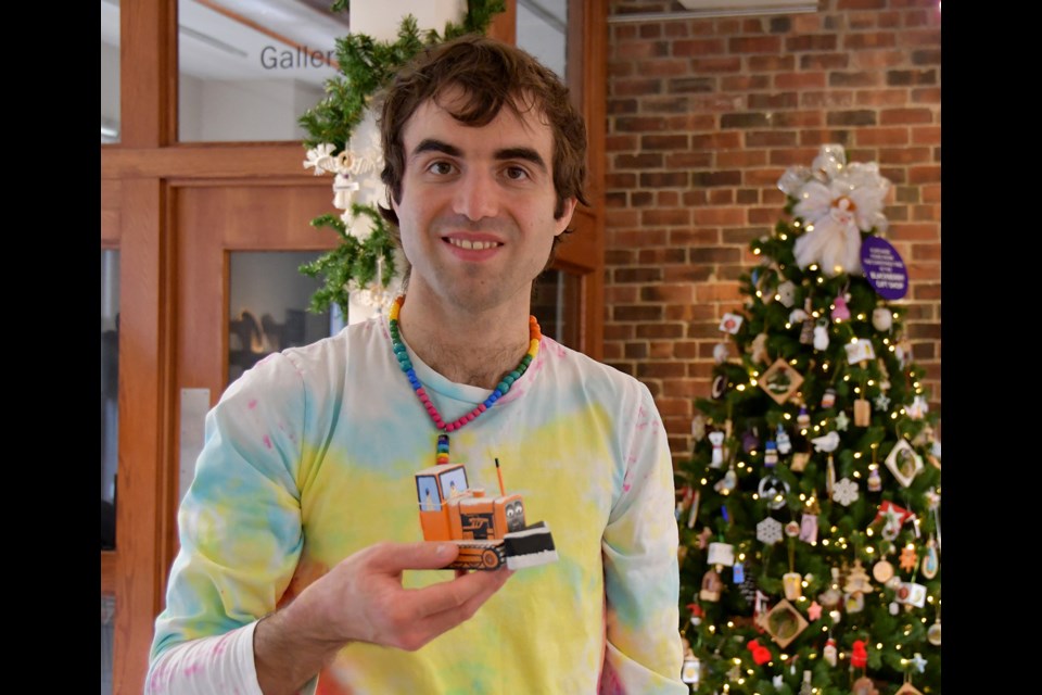 Port Coquitlam artist Alex Lecce holds a "Thomas the Tank Engine" inspired figurine at PoMoArts on Dec. 9, 2024.