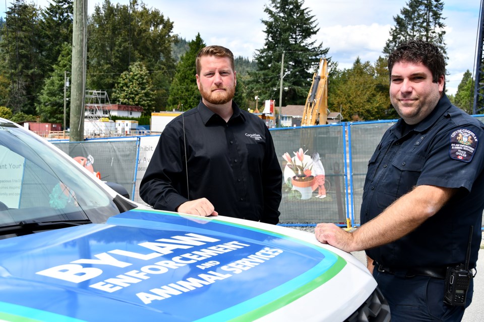 Coquitlam bylaw officer Kyle Kijowski, right, with Aaron Hilgerdenaar, left, the city’s manger of bylaw enforcement and animal services, at one of Coquitlam’s oldest neighbourhoods, Oakdale, on Monday, Aug. 19, 2024. The Burquitlam enclave off North Road is undergoing a massive transition following the arrival of SkyTrain.