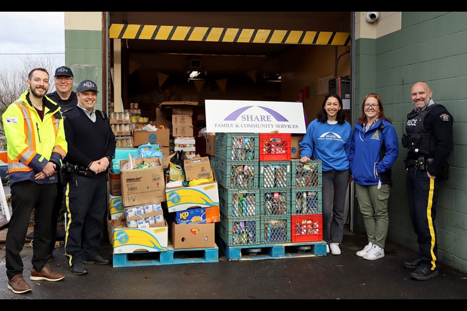 Coquitlam RCMP's annual Cram the Cruiser brought in 1,500 pounds of food and $1,500 for SHARE Family and Community Services on Dec. 7, 2024.