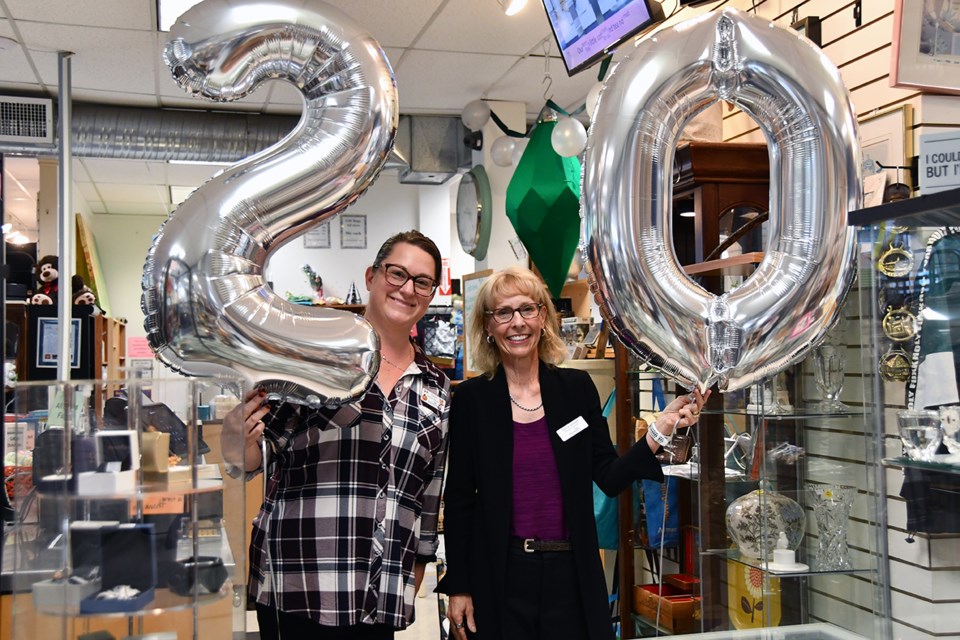 Taryn Kelley, left, assistant store manager, and Crossroads Hospice Society executive director Jackie Gorton celebrate the thrift store's 20th year on Aug. 20, 2024.