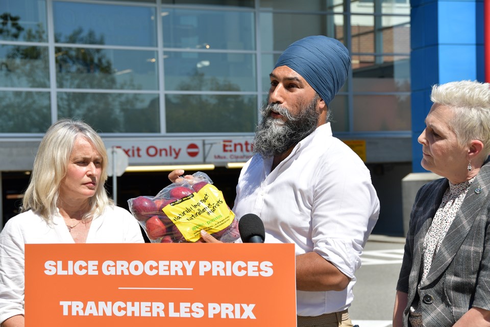 NDP leader Jagmeet Singh holds up a bag of apples outside Real Canadian Superstore in Coquitlam (3000 Lougheed Hwy.) to demonstrate the skyrocketing cost of grocery staples.