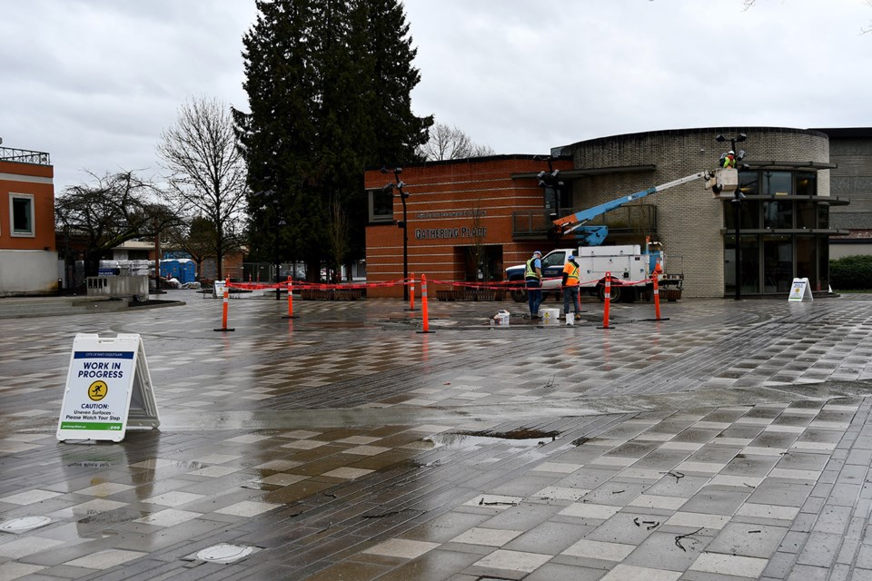 Workers in Port Coquitlam put on the finishing touches to Leigh Square, next to city hall, in March 2025.