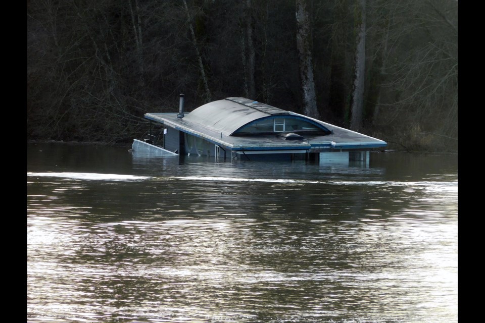 A privately held floating home is now half sunken in the Fraser River, north of Douglas Island by the Port Coquitlam shoreline.