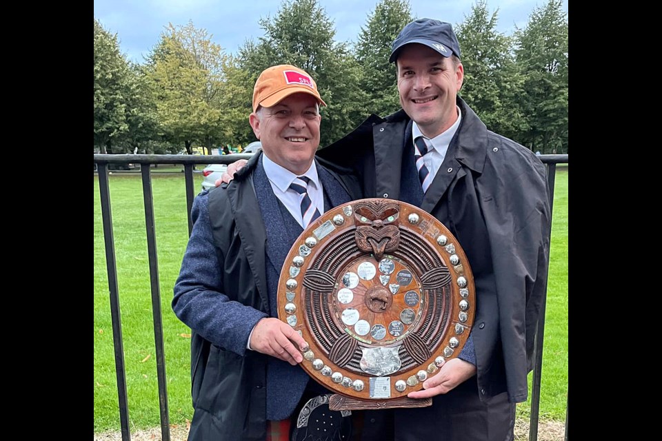 Coquitlam drummer J. Reid Maxwell and Pipe Major Alan Bevan celebrate the SFUPB's third place win at the Worlds on Aug. 17, 2024.