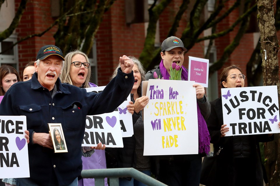 Supporters of murder victim Trina Hunt react to the honk from a passing motorist during a rally at СƵ Provincial Court in Port Coquitlam Wednesday.