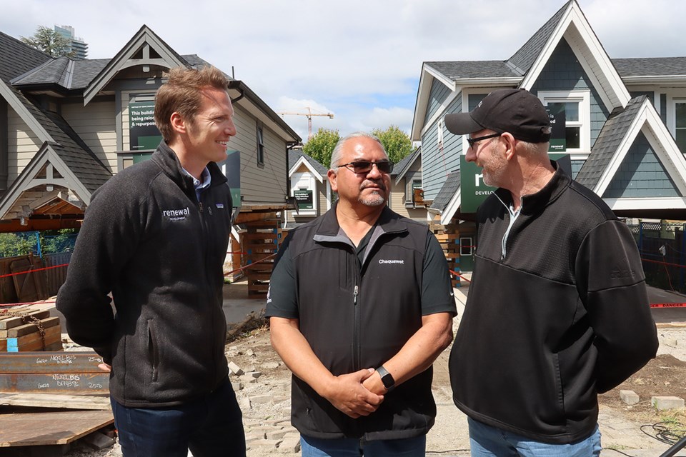 [From left to right] Glyn Lewis, of Renewal Development, and Sts'ailes Nation Grand Chief Willie Charlie chat with Jeremy Nickel, of Nickel Brothers which will transport the four homes in Burquitlam to their destination along the Harrison River in Agassiz.