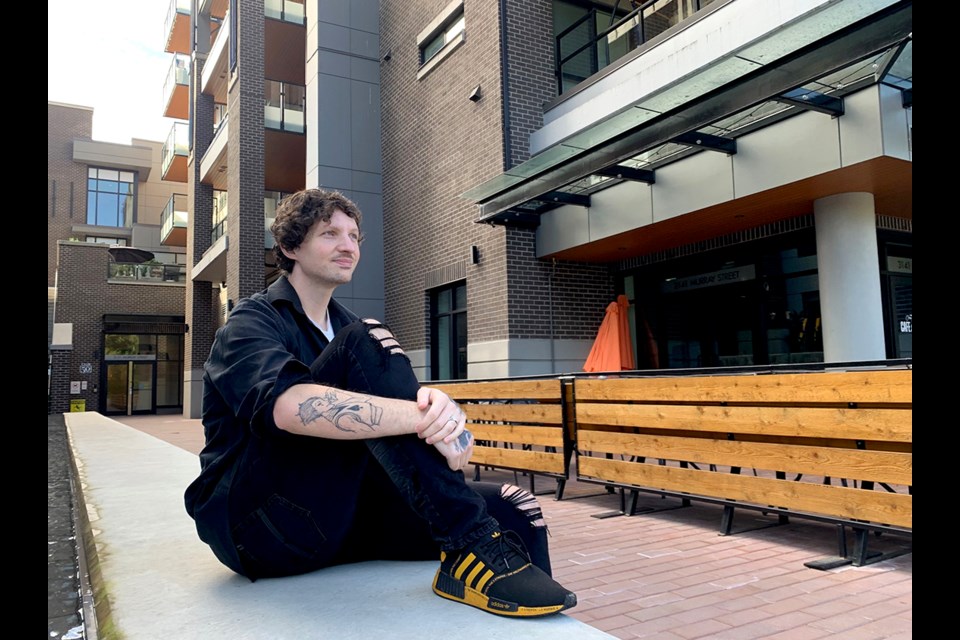 Christian Fracchia, 30, takes a break outside 50 Electronic Ave. in Port Moody, where he was able to purchase his first home with the help of a unique rent-to-own program.