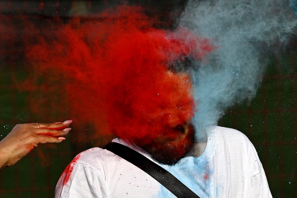 James Bernard of Mission is hit in the face with coloured powder.
