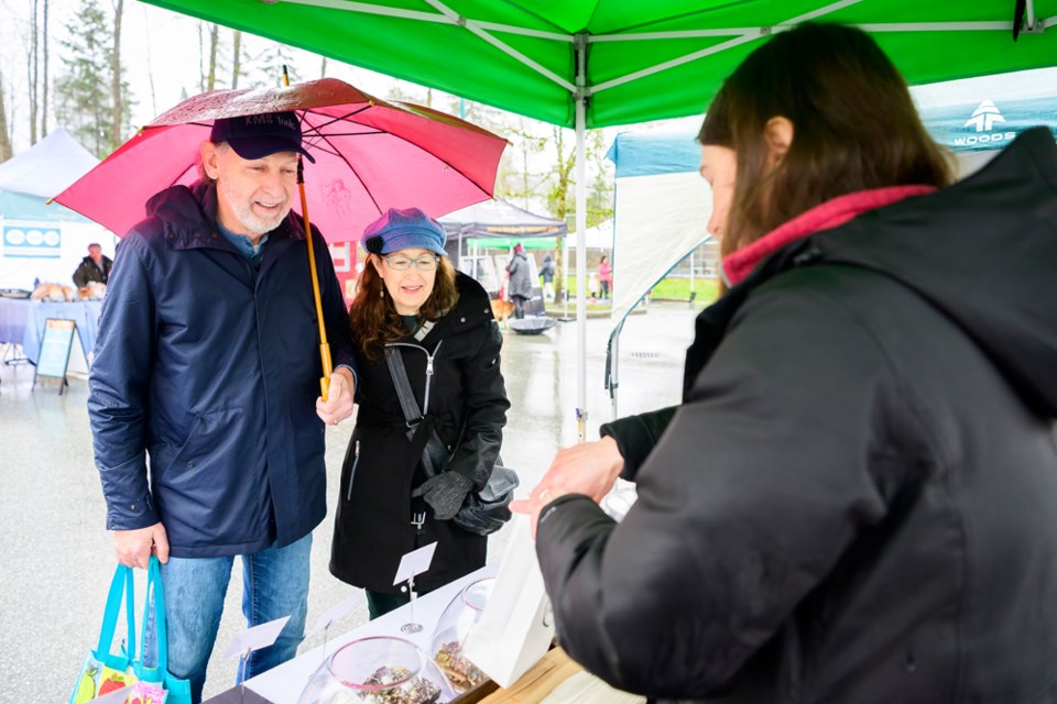 Nicole Fraser of Occasionally Honey serves up some treats for John and Marilyn Morrison of 
Newport Village.

