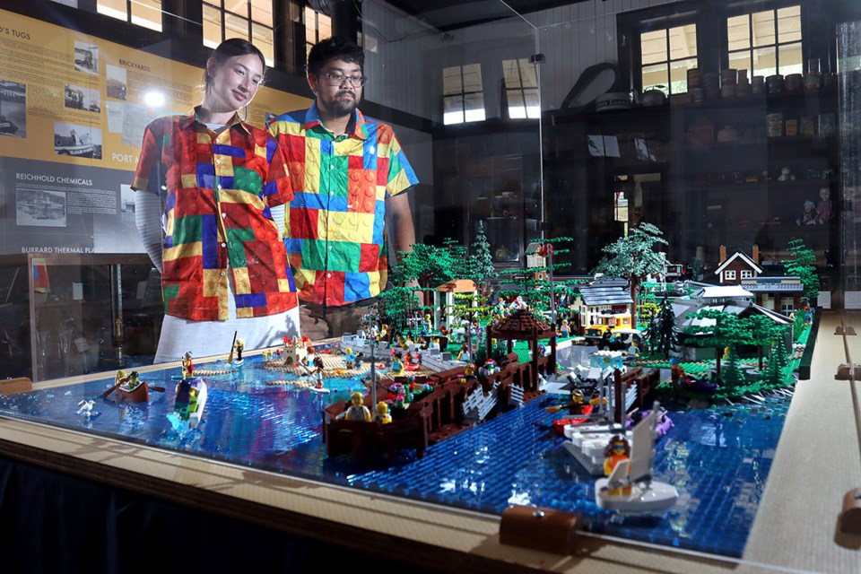 PoMo Museum assistants Brynn Cassells and Josh Navarra check out the 8X4 Lego model of Rocky Point Park that is the centrepiece of a new exhibit looking at the history of building blocks.