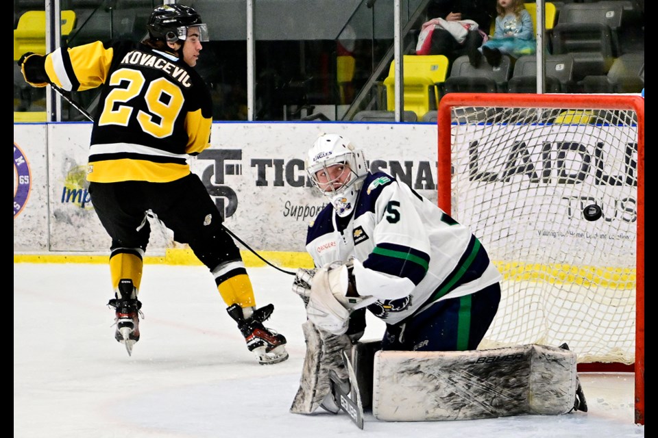 Andrej Kovacevic of the Coquitlam Express gets the puck past Surrey Eagles goaltender Aidan Fischer at the Poirier Sport and Leisure Complex on Feb. 17, 2025.
