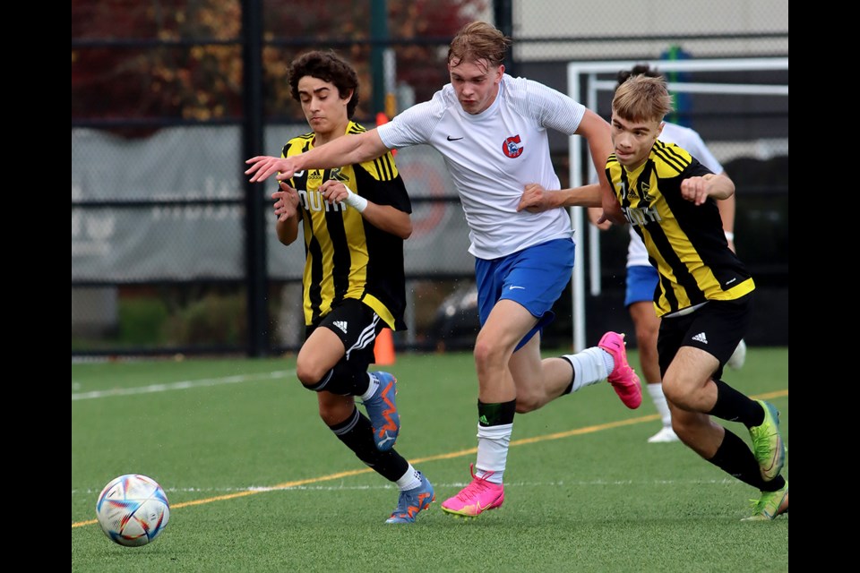 Centennial Centaurs forward Aidan Furney tries to squeeze through a pair of Burnaby South Rebels defenders in the first half of their Fraser North zone semifinal, Thursday at Centennial's turf field. The Centaurs won 4-1 and will play the Port Moody Blues for the championship next Thursday. Both teams have already earned a berth in the provincials.