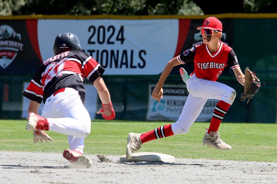 District 3 Firebirds shortstop Jayden Boudreau tries to make a play on Team Quebec baserunner Mathias Audette in the first inning of their semi-final game at the Canadian Intermediate Little Leage Championships, Tuesday at Mackin Park.