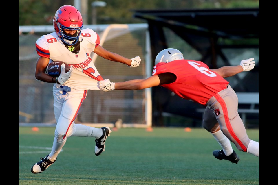 Centennial Centaurs running back Isaiah Lecesne escapes the grasp of a Holy Cross tackler in the first half of their BC Secondary School Football Association game, Friday at the Centennial turf field. The Centaurs won, 34-0.