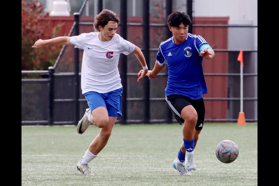 Pinetree Timberwolves forward Nicholas Lam gets past Centennial Centaurs defender Gabe Quiring in the first half of their Fraser North senior boys high school soccer match, Thursday at Centennial's turf field. The Centaurs won, 2-0.