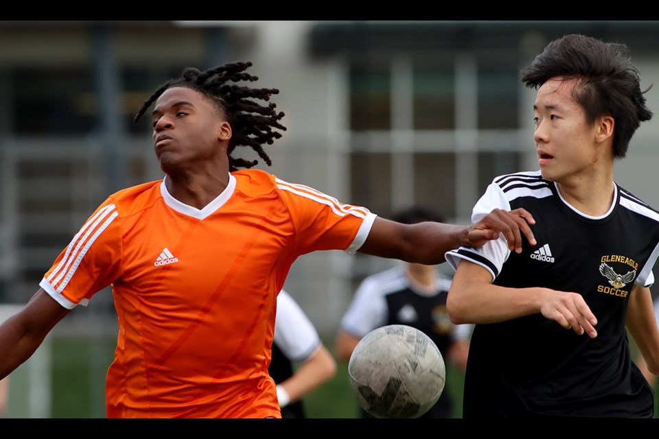 New Westminster Hyacks forward Daniel Remple-White battles with Gleneagle Talons defender Noah Kim  in the first half of their match at the Fraser North zone championships, Thursday at New West Secondary School.
