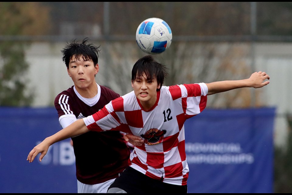 Heritage Woods Kodiaks forward Daniel Huang battles a Lake City player in the first half of their prelminary round match last Friday, Nov. 22, at the BC boys AAA high school soccer championships. The Kodiaks won the match, 3-0, and finished fifth at the tournament.