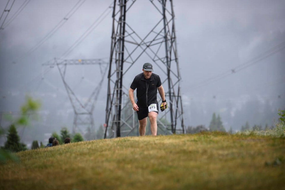 Shawn Spencer grinds his way up the Coquitlam Crunch at Saturdays annual Diversity Challenge. Dozens of climbers ascended and descended the 2.2 km climb through rain and mist in four categories, including the Stair Master race to see who could climb the Crunchs 437 steps the fastest, the 8 km run, the Make It or Break It that challenged participants to complete the 4.4- km return loop as often as possible in four hours, and a recreational division. | Jennifer Gauthier, Tri-City News