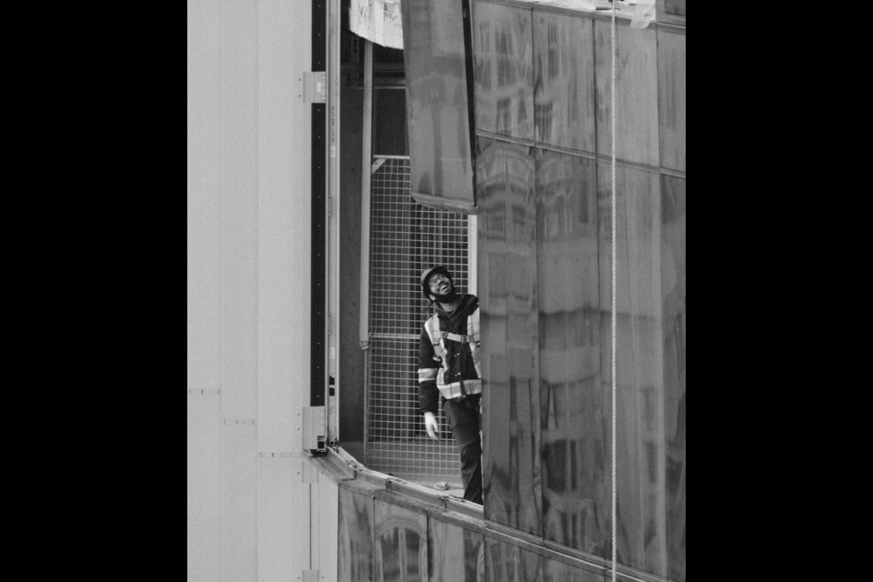 Vancouver, BC artist Raphael Esiriel captured a construction worker's contagious grin when he spotted him on the side of a statuesque building. 