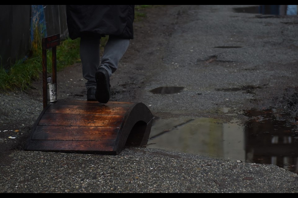 Keenan Domerecki created a little bridge for a large sidewalk puddle on Vancouver's Main Street.