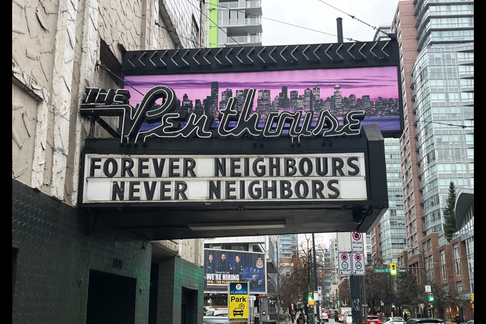 The four-word message uses the Canadian and U.S. spellings of the word "neighbour" to make a point.