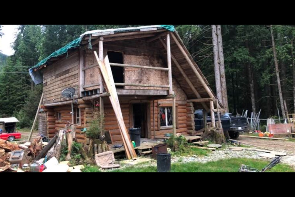 The outer view of a cedar cabin listed for sale on Facebook Marketplace