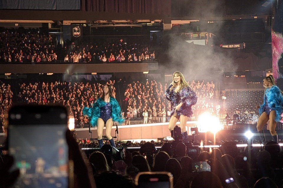 Taylor Swift performs the "Midnights" set of her Eras Tour show in Toronto on Nov. 15, 2024. Fans in Vancouver have joined up to take part in special gestures each of the three nights the pop icon will be in town at BC Place in December.