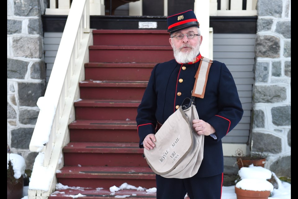 Rob MacDonald poses in his replica postal uniform worn by the first letter carriers in Vancouver.