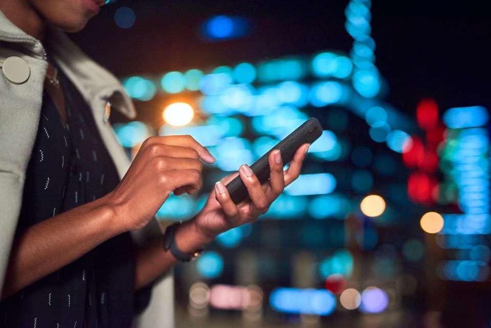 woman-alone-cellphone-city-night