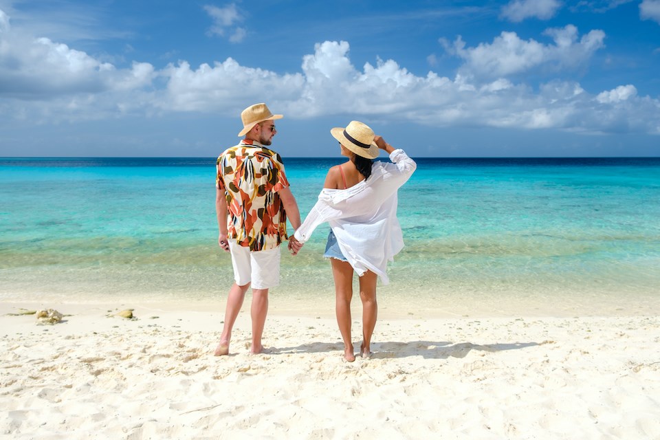 couple-on-beach-teal-water