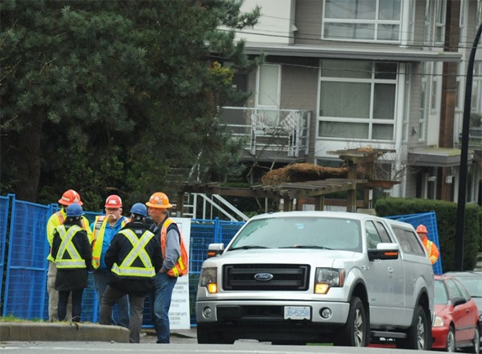  Work crews wait outside a 15th Street construction site Thursday morning, the day after their colleague was killed in a fall. WorkSafeBC is now investigating. photo Mike Wakefield, North Shore News