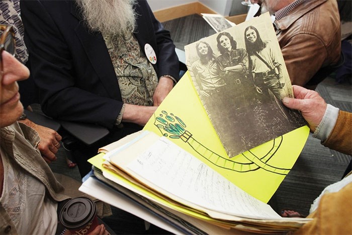  Students and teachers leaf through scrapbooks while trading stories about the bands they saw and the injuries they sustained - photo Lisa King