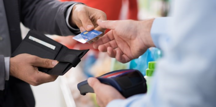  Customer making purchase in store/Shutterstock