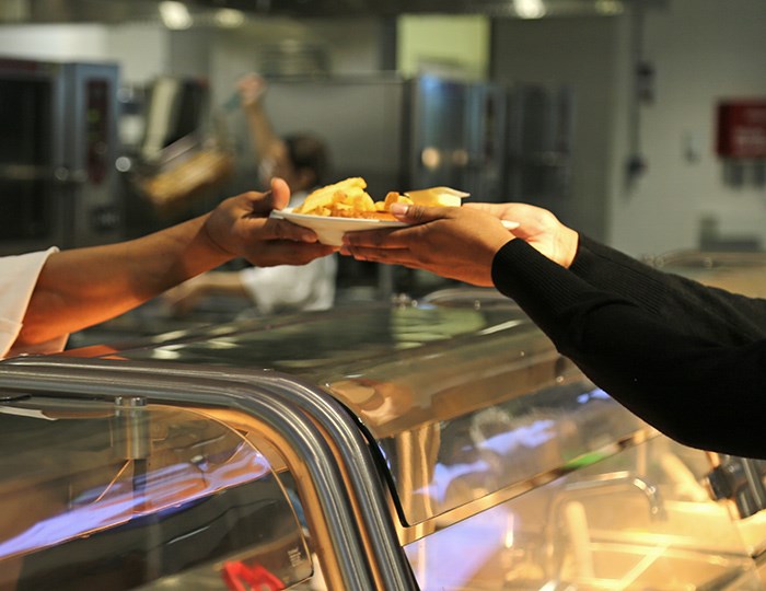  Ikea fish n' chips being handed to a customer in their cafeteria in Richmond. Photo Bob Kronbauer