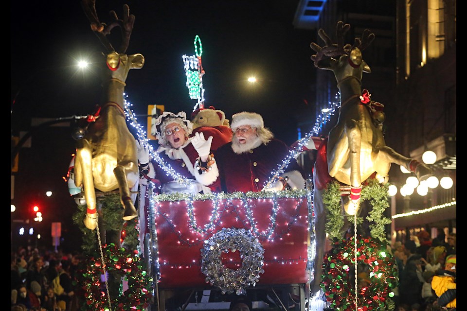 Santa and Mrs. Claus wave and sing as they hit the streets in their souped-up sleigh — it was sporting new decorations and some extra lights this year — as part of the 41st Peninsula Co-op Santa Claus Parade in downtown Victoria on Saturday, Nov. 25, 2023. ADRIAN LAM, TIMES COLONIST