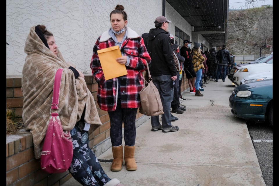 Evacuated residents of Merritt, saʴý, line up at a reception centre in Kelowna, saʴý, Thursday, Nov. 18, 2021.THE CANADIAN PRESS/Jeff McIntosh