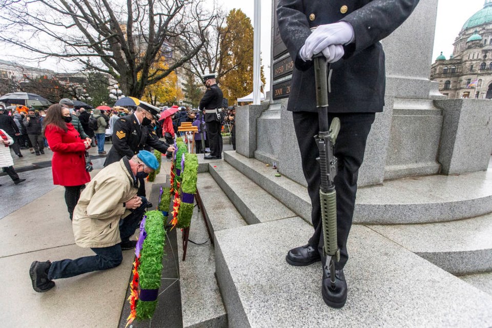 People place poppies on the cenotaph after Remembrance Day ceremonies at the B.C. legislature in Victoria on Thursday, Nov. 11, 2021.  DARREN STONE, TIMES COLONIST