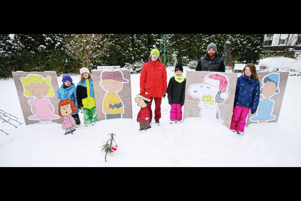 Whitney Davis, centre, and her family with the figures she helped create after three Peanuts characters in a seasonal display were stolen from Entrance Park in Oak Bay. From left, Sterling Hochhalter, 5, Pascal Hochhalter, 7, Davis, Brighton Hochhalter, 9, partner Blair Hochhalter and Cassidy Hochhalter, 11. ADRIAN LAM, TIMES COLONIST Dec. 28, 2021 