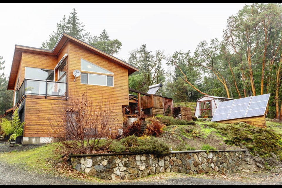 A side view of the cottage and the greenhouse behind it. DARREN STONE, TIMES COLONIST 