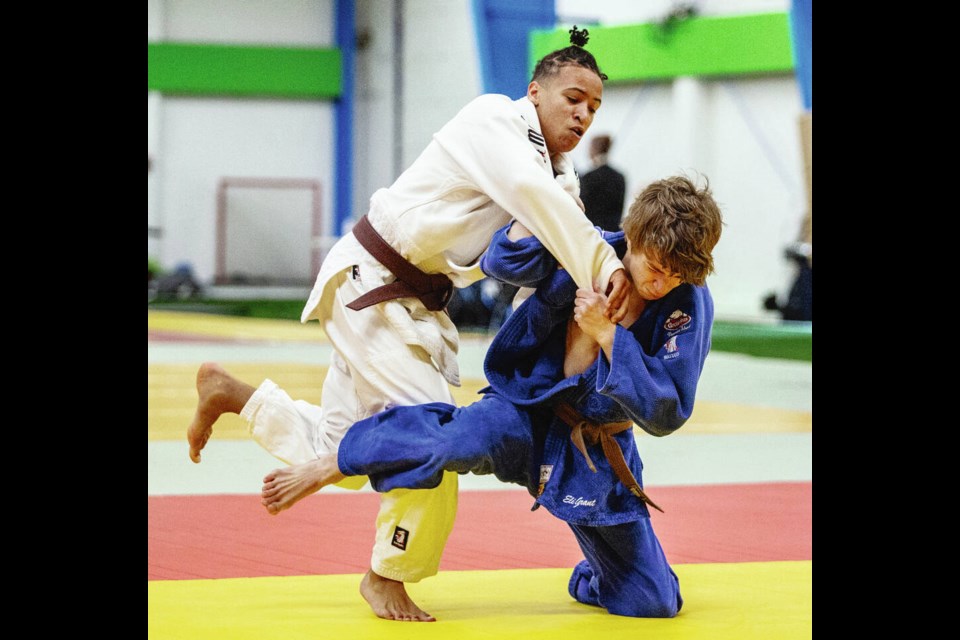 Eli Grant of Victoria’s Kokushikai Judo, in blue, tries to take down Joshua Wiebe of Abbotsford Judo in the U21 men’s 60-kilogram bronze medal match during the Judo B.C. Youth Provincial Championships at the Westshore Recreation Centre on Saturday. Grant won the match to capture the bronze. DARREN STONE, TIMES COLONIST