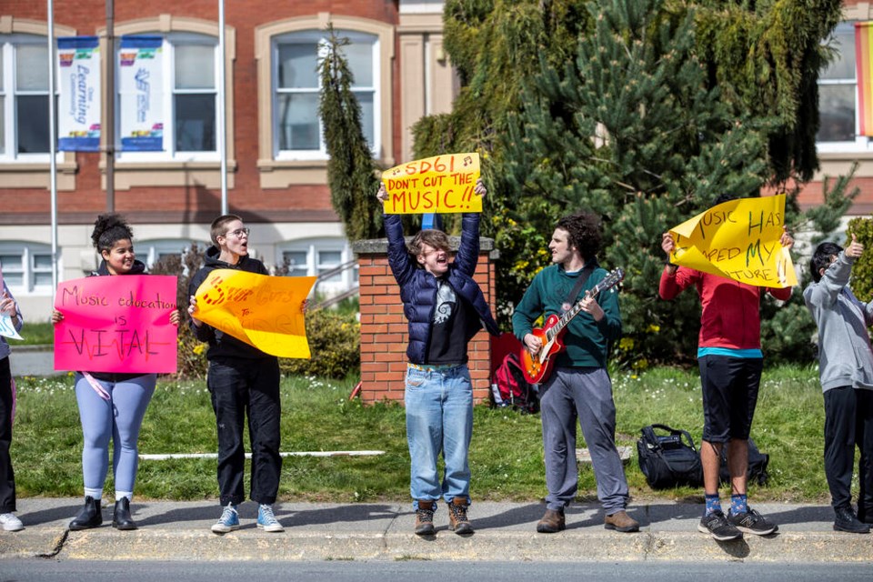 Students protest cuts to music programs in front of the Greater Victoria School District offices on Boleskine Road on Friday. DARREN STONE, TIMES COLONIST  