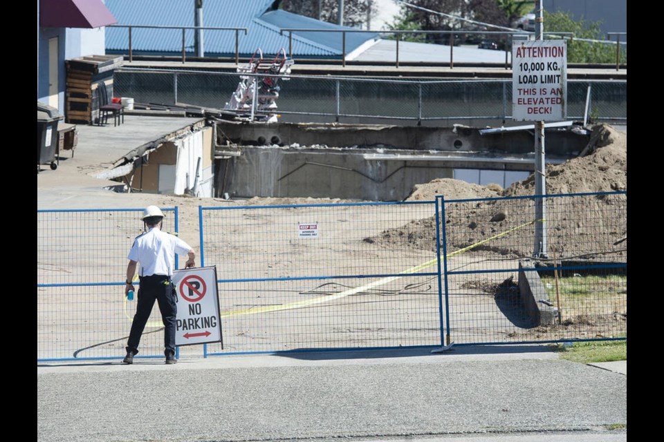 Emergency services were called to collapsed parking garage roof at a business on East Broadway near Rupert Street in Vancouver on Thursday, July 14, 2022. JASON PAYNE, PNG