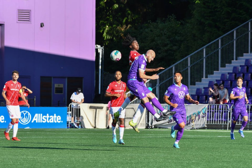 Pacific FC defender Jordan Haynes goes up for a header against Cavalry FC at Starlight Stadium on 
Thursday night. TRISHA LEES, PACIFIC FC 