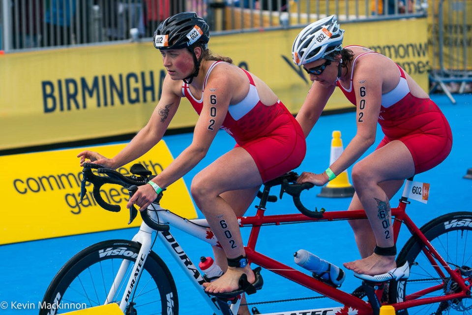 Triathlete Jessica Tuomela, right, competes in the women’s para-triathlon race with guide Emma Skaug at the Birmingham Commonwealth Games on Sunday, July 31, 2022. KEVIN MacKINNON