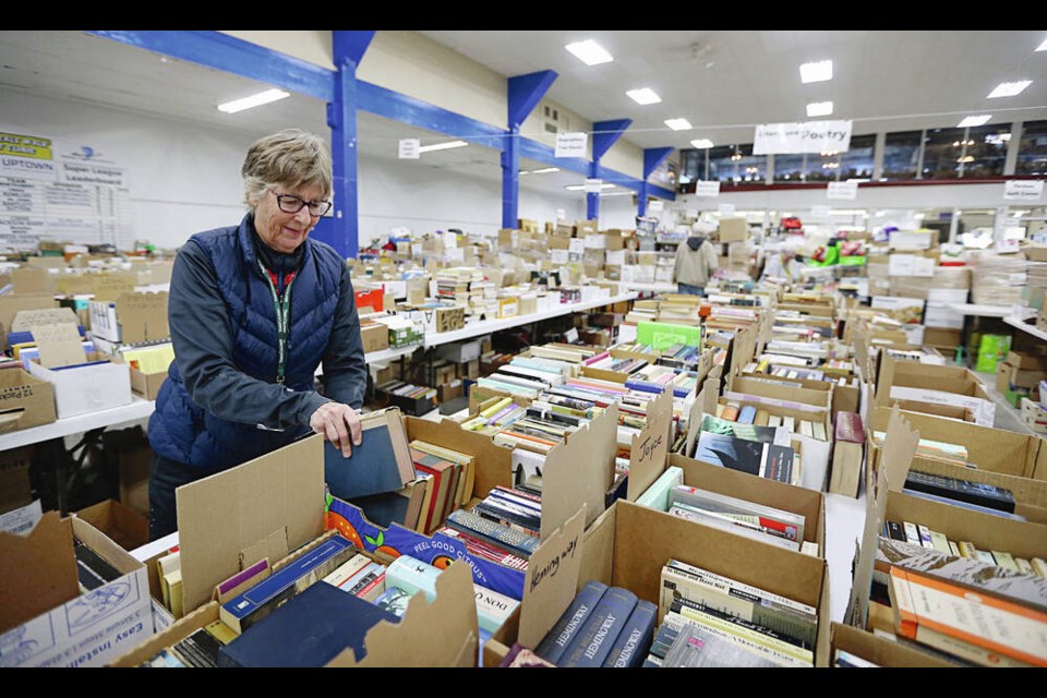 Veronica Allan sorts books for the saʴý book sale at the Victoria Curling Club. The sale is on ­Saturday and Sunday, May 6 and 7. ADRIAN LAM, TIMES COLONIST 