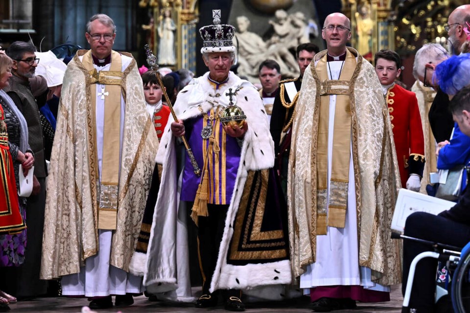 Britain's King Charles III wearing the Imperial state Crown and carrying the Sovereign's Orb and Sceptre leaves Westminster Abbey after coronation in central London Saturday, May 6, 2023. The set-piece coronation is the first in Britain in 70 years, and only the second in history to be televised. Charles will be the 40th reigning monarch to be crowned at the central London church since King William I in 1066. (Ben Stansall/POOL photo via AP)