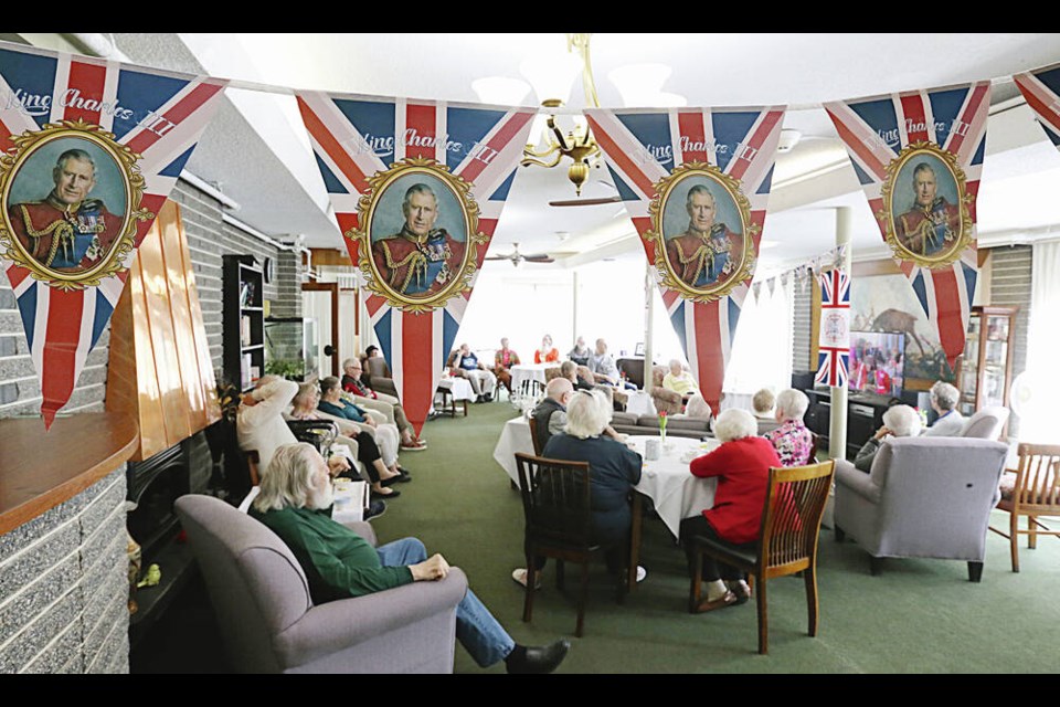 Residents watch a replay of the coronation ceremony at The Glenshiel on Douglas Street, operated by the Glenshiel Housing Society.  ADRIAN LAM, TIMES COLONIST  