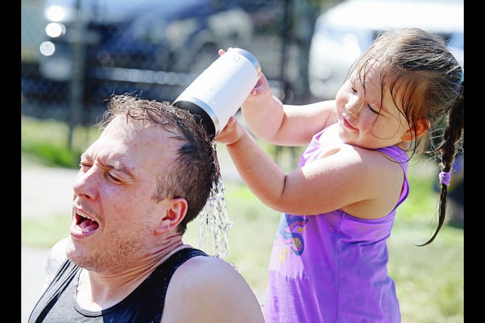 Aurelia Bouchard and her dad Abel play at the waterpark on Karr Road in Langford on a hot and sunny Saturday. ADRIAN LAM, TIMES COLONIST 